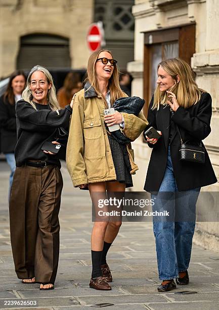 Guest is seen wearing a tan jacket, gray skirt, brown shoes, black socks and black eyewear outside the Zimmermann show during the Womenswear Spring...