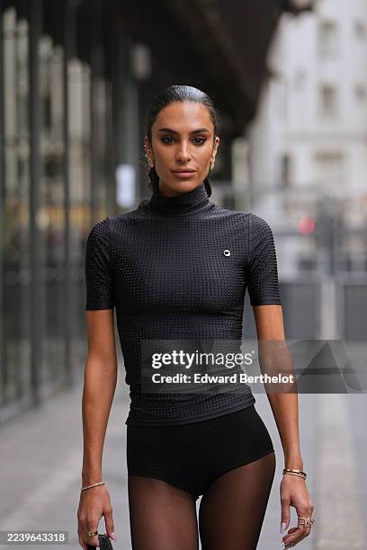 Jessica Aïdi Verratti wears a slicked-back low ponytail, long dark brown hair with no prominent part, silver stud earrings, mixed gold and silver...
