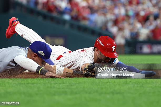Trea Turner of the Philadelphia Phillies is tagged out at third base by Miguel Rojas of the Los Angeles Dodgers to end the sixth inning in game two...