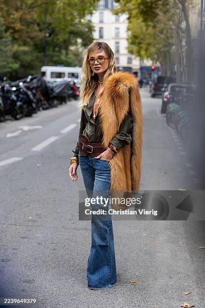 Guest wears fur scarf, flared jeans outside Zimmermann during the Womenswear Spring Summer 2026 as part of Paris Fashion Week on October 06, 2025 in...