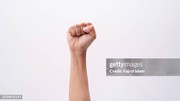 hand clenched something isolated on white background - faust stock-fotos und bilder