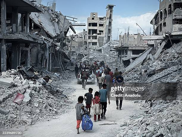 Palestinians begin to return their homes damaged and destroyed homes following the Israel announcement on Friday that the ceasefire agreement came...