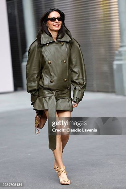 Guest wears olive green leather jacket/dress with low waisted belt, beige sandals, outside Zimmermann, during the Womenswear Spring Summer 2026 as...