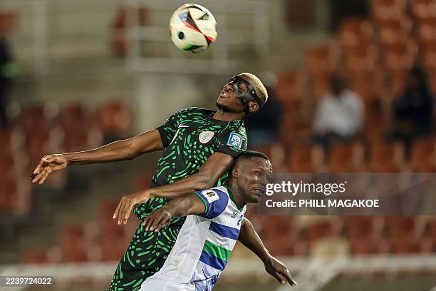 Nigeria's forward Victor Osimhen jumps to head the ball as he is challenged by Lesotho's defender Motlomelo Mkhwanazi during the FIFA World Cup 2026...