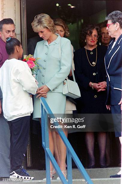 5th June, 1996 - Diana, Princess of Wales, on a visit to Chicago, visits Cook County Hospital. As Diana left the hospital a young fan presented her...