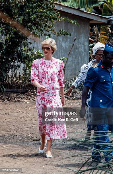 Princess Diana, Princess of Wales, wearing a pink-and-white floral patterned Paul Costelloe dress, during a visit to the farming village of Umuagbai...