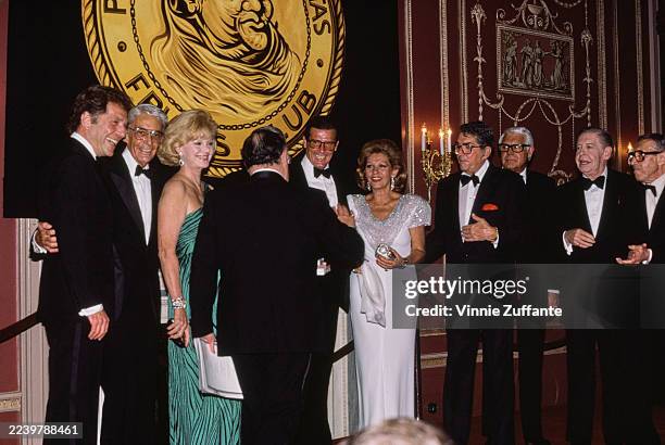 American actor George Segal, unidentified, American model Barbara Sinatra, unidentified, English actor Roger Moore, Italian actress Luisa Moore,...