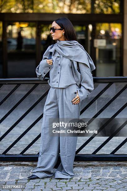 Guest wears grey jacket, wide leg pants outside Christopher Esber during the Womenswear Spring Summer 2026 as part of Paris Fashion Week on October...