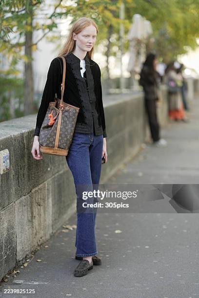Lucy Arbuthnott is seen wearing a black jacket, white top, dark blue jeans, suede shoes and carrying a Louis Vuitton bag during the Womenswear Spring...