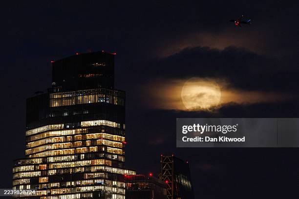 The harvest moon rises over the City of London on October 7, 2025 in London, England. The full harvest moon, is the first of three supermoons before...