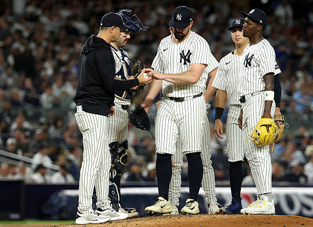 Carlos Rodón of the New York Yankees reacts on the mound as he is taken out of the game by Manager Aaron Boone against the Toronto Blue Jays during...