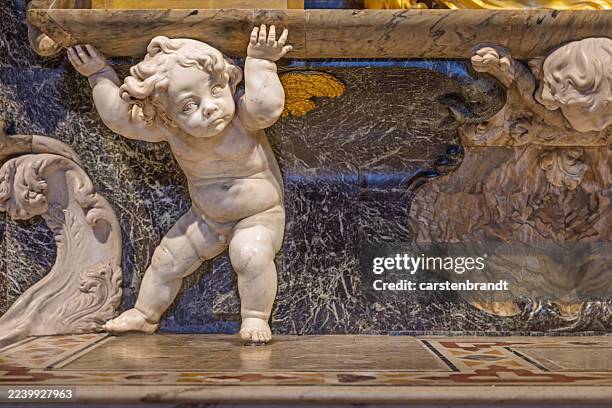 marble cherub supporting altar structure in toledo cathedral - cherub statue stock pictures, royalty-free photos & images