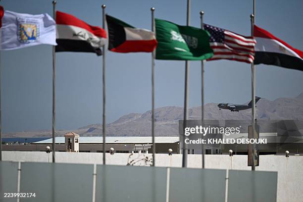 Flags of several countries flutter as a US military aircraft prepares to land in Sharm el-Sheikh, ahead of the arrival of international leaders to...