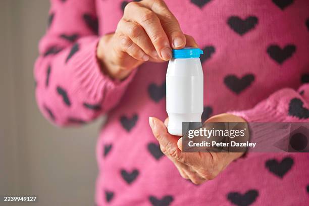 holding a bottle of probiotic drink . - organismo acidófilo imagens e fotografias de stock