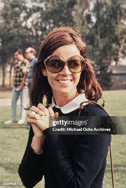 Franco-American singer and actress Claudine Longet wearing a white shirt, blue knitted blue sweater and large sunglasses, Los Angeles, 1970. Longet...