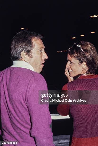 American singer Andy Williams, wearing a purple knitted sweater, with his partner Franco-American singer and actress Claudine Longet, who wears a...