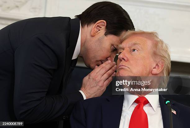 Secretary of State Marco Rubio speaks to U.S. President Donald Trump during a roundtable discussion in the State Dining Room of the White House on...