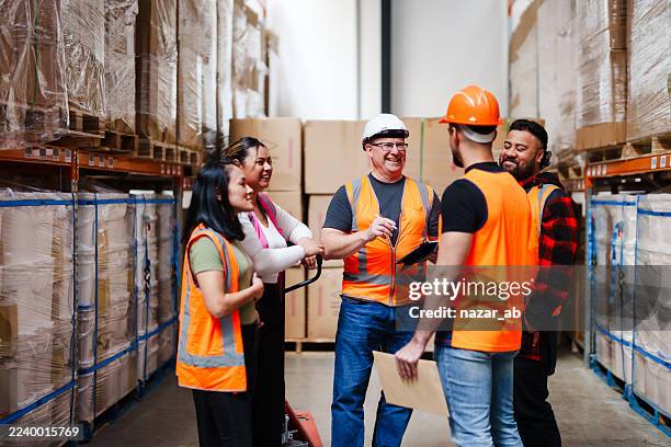 teamwork in action, logistics staff using digital tools. - warehouse worker stock pictures, royalty-free photos & images
