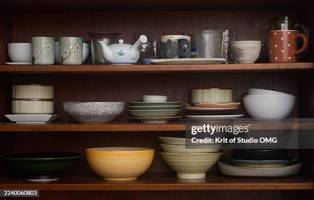 rustic kitchen storage with handmade ceramic dishes - kitchen store cupboard stock pictures, royalty-free photos & images