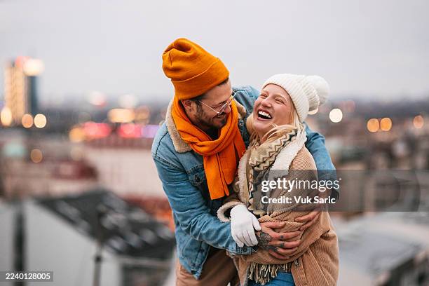 happy young couple laughing together outdoors in winter - belgrade serbia stock pictures, royalty-free photos & images