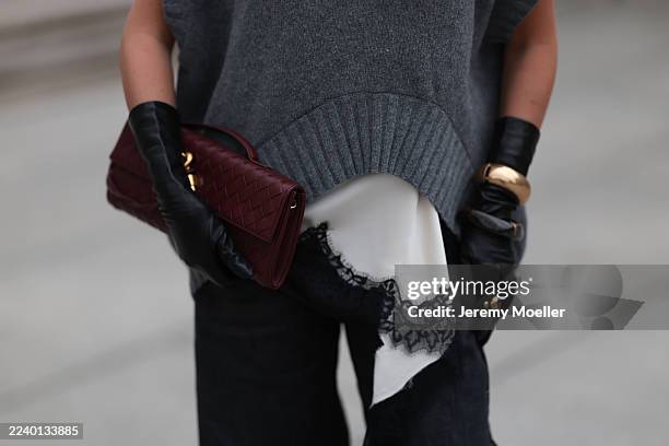Olga Liber with blonde wavy hair seen wearing a Zara look featuring a grey oversized knit vest layered over a white satin lace-trim camisole and...