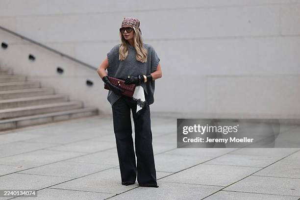 Olga Liber with blonde wavy hair seen wearing a Zara look featuring a grey oversized knit vest layered over a white satin lace-trim camisole and...