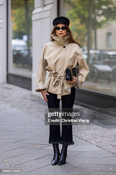 Lisa Mottl wears beige trench coat jacket Zara, black cuffed pants Zara, ankle boots Khaite, hat vintage Dior, vintage Chanel bag, sunglasses Vehla...