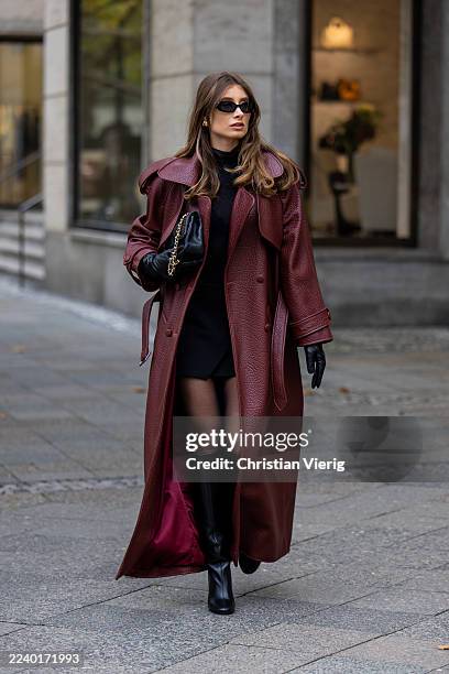 Lisa Mottl wears burgundy red trench coat Kaoa, black turtleneck Calzedonia, skirt Pull and Bear, tights Falke, bag Vintage Chanel bag, knee high...
