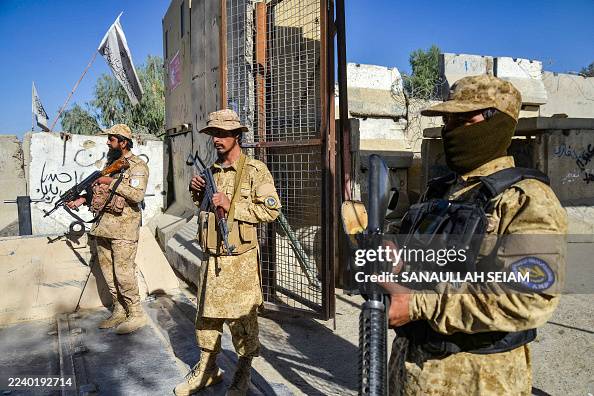 Talib Guard Armed Taliban security personnel keep guard near the closed gate of ...