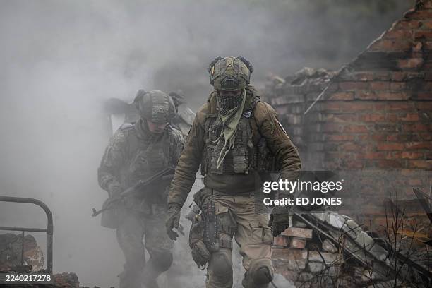 Infantry recruits of the 28th Seperate Mechanized Brigade take cover from a grenade blast as they undergo a basic training course at an undislosed...
