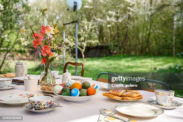 prepared easter table in the garden - easter breakfast stock pictures, royalty-free photos & images