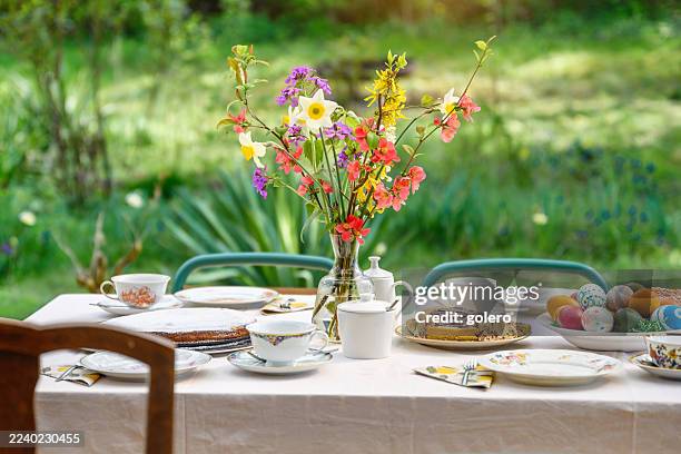 prepared easter table in the garden - easter breakfast stock pictures, royalty-free photos & images