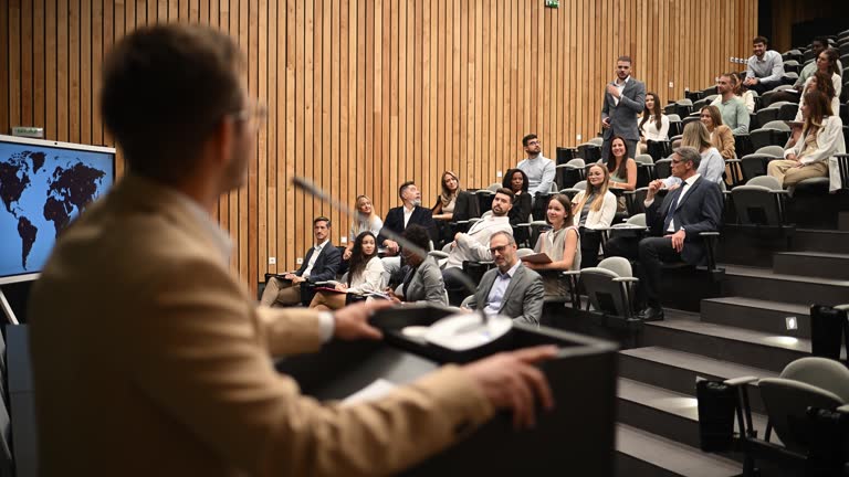 https://media.gettyimages.com/id/2240233823/video/professor-interacting-with-students-during-a-business-seminar.jpg?b=1&s=640x640&k=20&c=K9c_UAC-lqcbMTPrAaMLYe9jxTSQV3g7nYp0oHswHCE=
