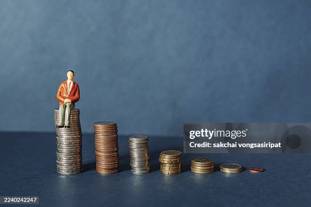 elderly people sitting on coin, time counting down for retirement concept, social security income and pensions - pension stock pictures, royalty-free photos & images
