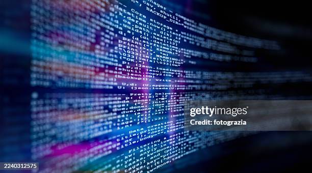 computer code on screen with abstract digital background - code stockfoto's en -beelden