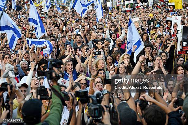 People react as they watch the hostage release live stream at Hostages Square on October 13, 2025 in Tel Aviv, Israel. The ceasefire deal between...