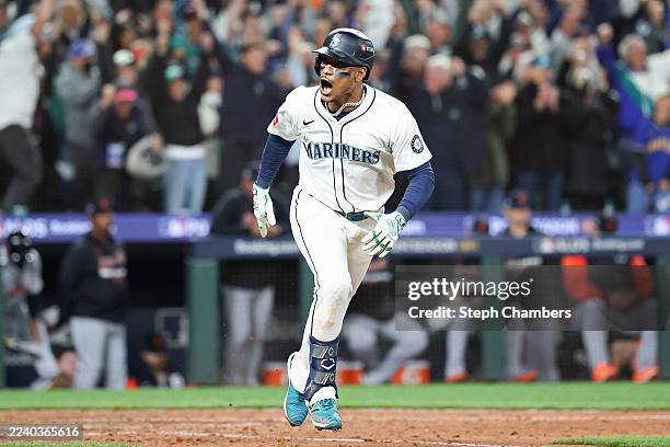 Jorge Polanco of the Seattle Mariners celebrates after hitting the game-winning RBI single during the fifteenth inning against the Detroit Tigers to...