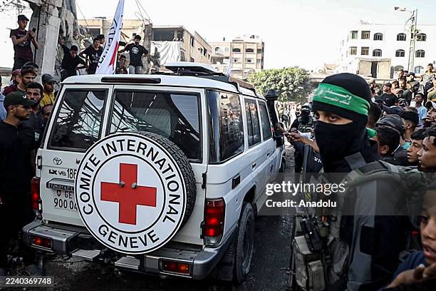 Hamas members hand over some of the 20 Israeli hostages to International Committee of the Red Cross teams as part of the ceasefire and...