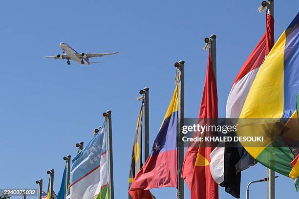 Norwegian aircraft flies over the congress centre in the Egyptian Red Sea resort town of Sharm el-Sheikh on October 13 ahead of the Sharm El-Sheikh...