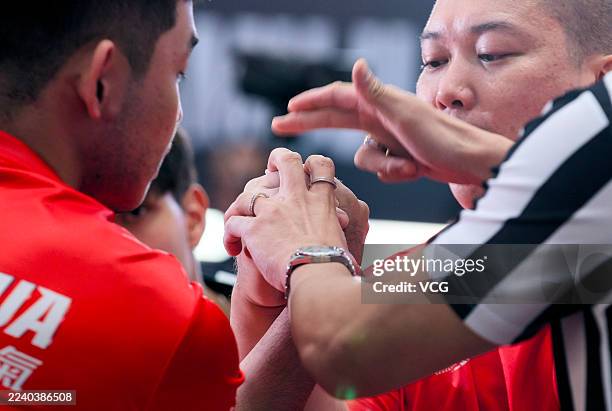 Participants compete in Hong Kong International Arm Wrestling Championship at a shopping mall in Tsim Sha Tsui on October 11, 2025 in Hong Kong,...
