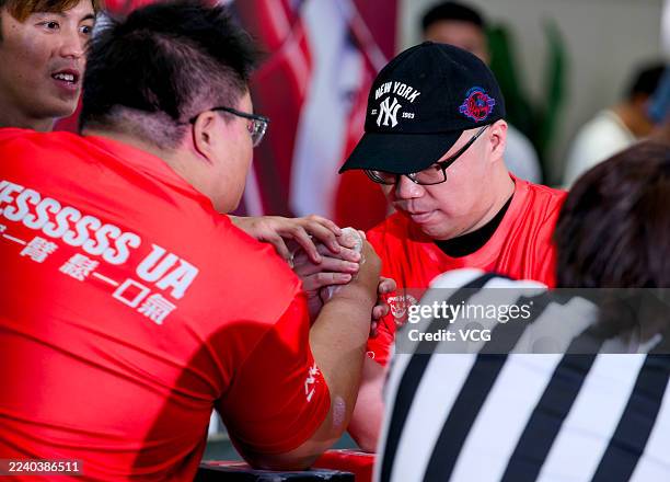 Participants compete in Hong Kong International Arm Wrestling Championship at a shopping mall in Tsim Sha Tsui on October 11, 2025 in Hong Kong,...