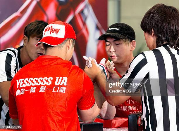 Participants compete in Hong Kong International Arm Wrestling Championship at a shopping mall in Tsim Sha Tsui on October 11, 2025 in Hong Kong,...