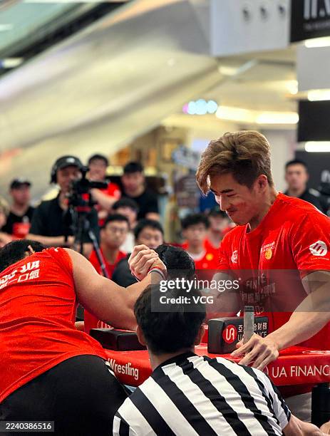 Participants compete in Hong Kong International Arm Wrestling Championship at a shopping mall in Tsim Sha Tsui on October 11, 2025 in Hong Kong,...
