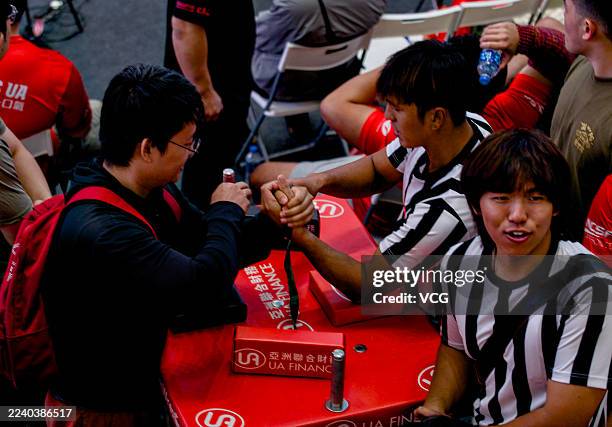 Participants compete in Hong Kong International Arm Wrestling Championship at a shopping mall in Tsim Sha Tsui on October 11, 2025 in Hong Kong,...