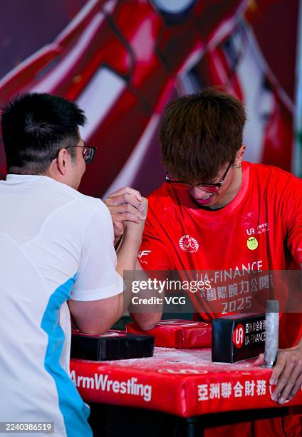 Participants compete in Hong Kong International Arm Wrestling Championship at a shopping mall in Tsim Sha Tsui on October 11, 2025 in Hong Kong,...