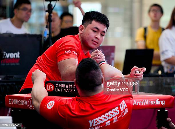 Participants compete in Hong Kong International Arm Wrestling Championship at a shopping mall in Tsim Sha Tsui on October 11, 2025 in Hong Kong,...