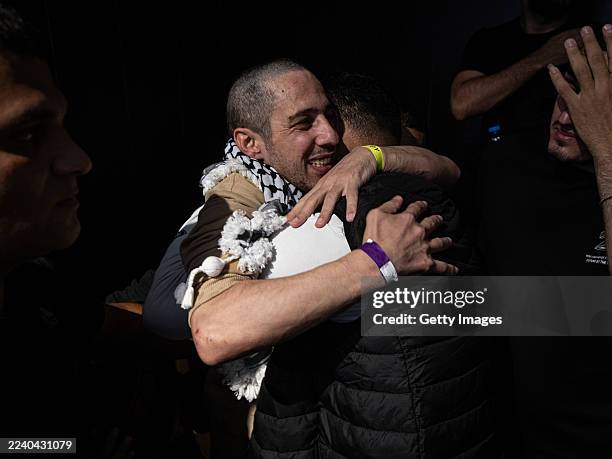 People embrace as newly released Palestinian prisoners return from Israeli jails on October 13, 2025 in Ramallah, West Bank. Israel is expected to...