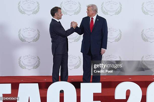 President Donald Trump greets France's President Emmanuel Macron during a summit of European and Middle Eastern leaders on October 13, 2025 in Sharm...