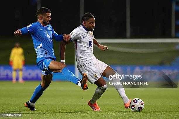 Iceland's defender Victor Palsson and France's forward Christopher Nkunku vie for the ball during the 2026 World Cup qualifying round Group D...
