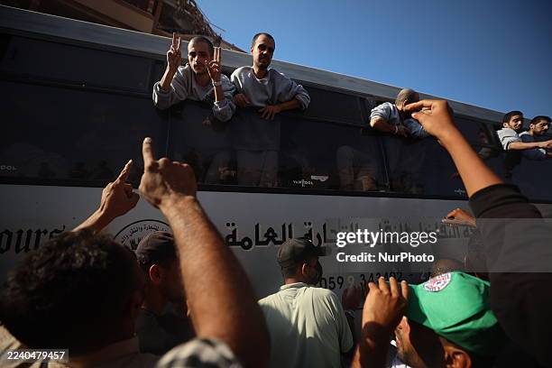 Buses carrying Palestinians released from Israeli prisons under a Gaza ceasefire and hostage exchange deal with Palestinian factions arrive outside...